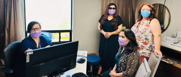 4 people wearing masks in hotel clinic