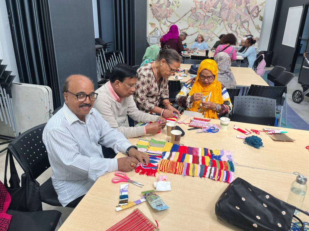 Participants weaving tapestries together
