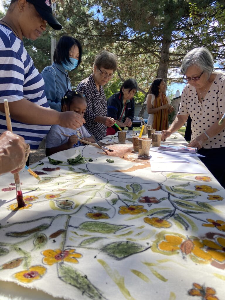 Participants painting a communal canvas together