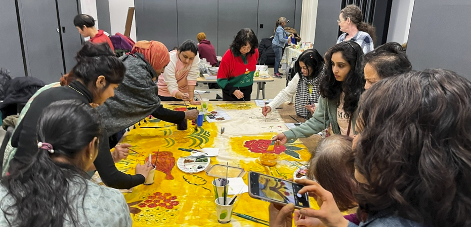 Expressive Arts group using natural herbs and food to paint a collective canvas.