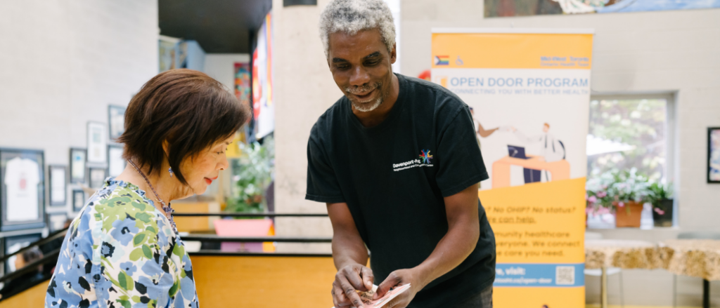 Davenport Perth CHC worker helping older woman at Open Door Program drop-in
